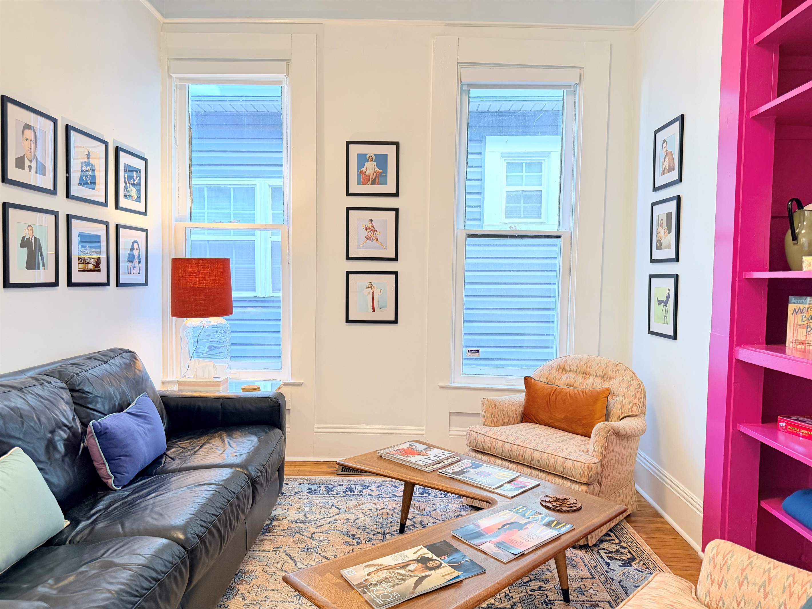 Ridiculously comfortable leather sofa layered with velvety-soft pillows and cozy blankets — designed for long afternoon reads and even longer naps.