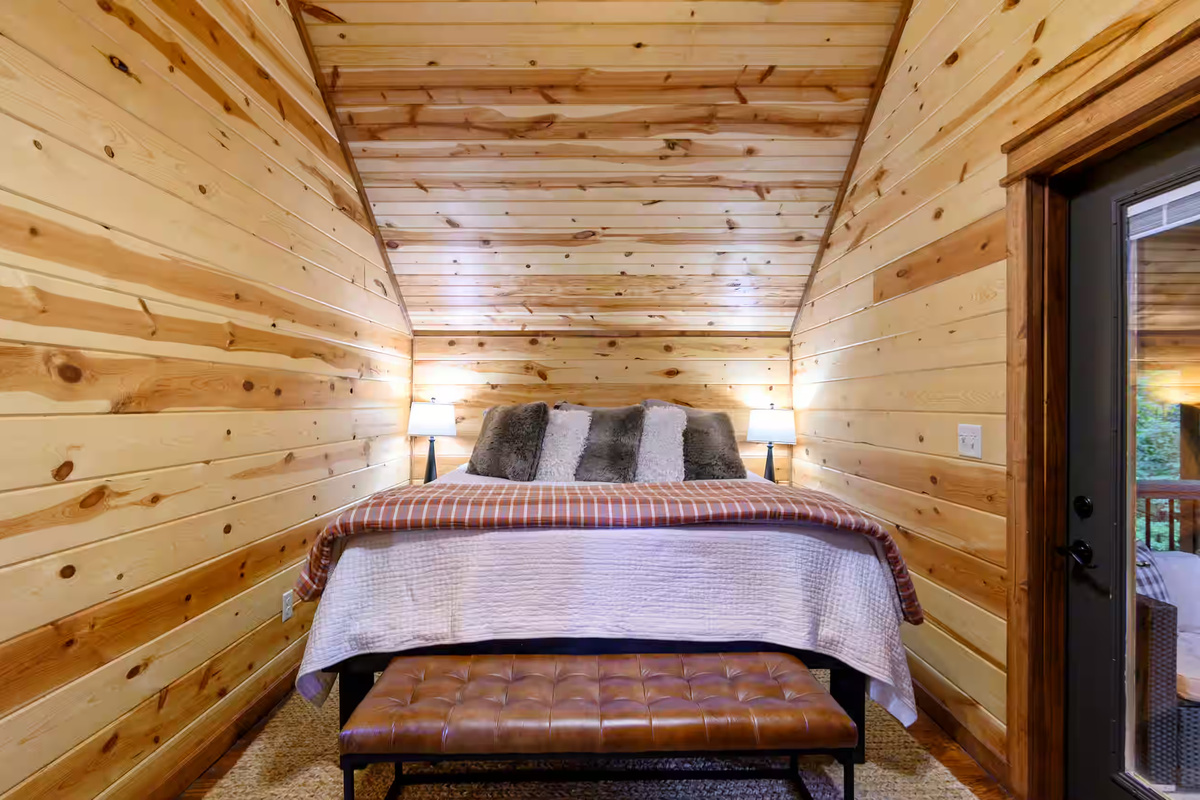 Charming Bedroom Retreat: Discover wood-paneled elegance and stylish comfort for restful nights!