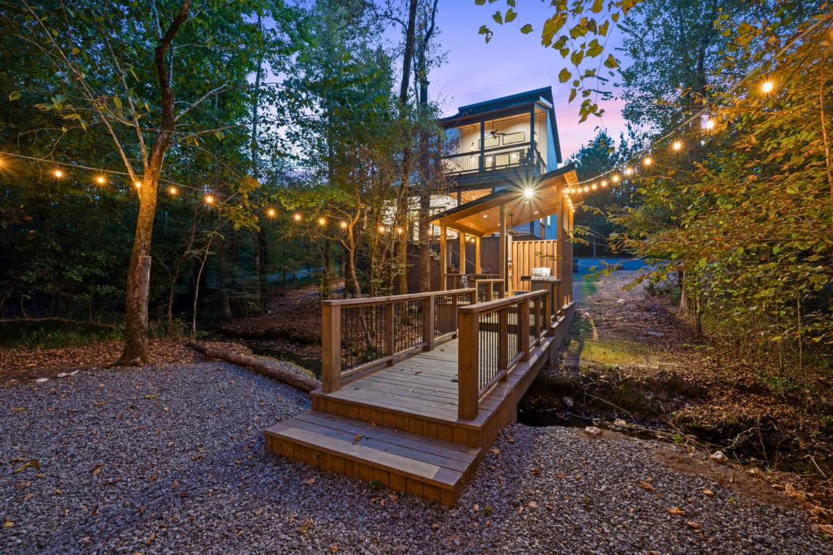Follow the steps down from the deck to the outdoor gathering space, where string lights add a warm glow in the evenings.