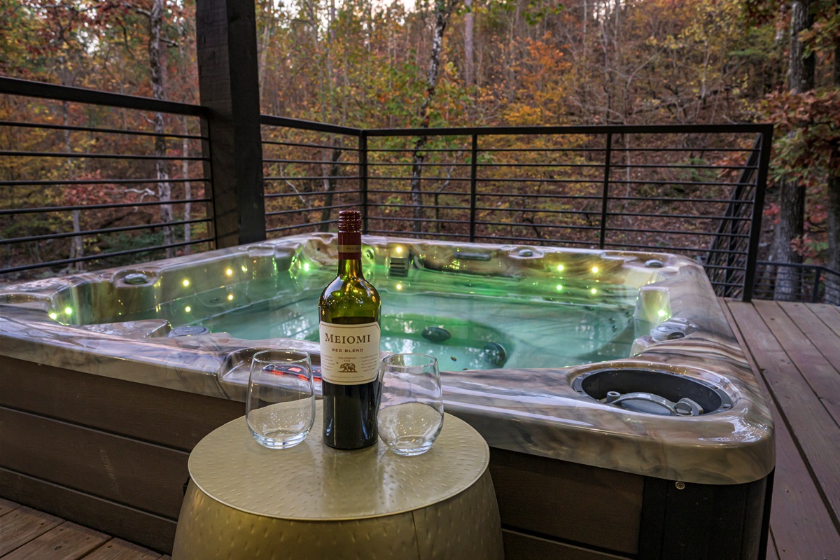 Escape to the pines… come stay with us and enjoy a private hot tub, sparkling lights, and a glass of wine under the trees
