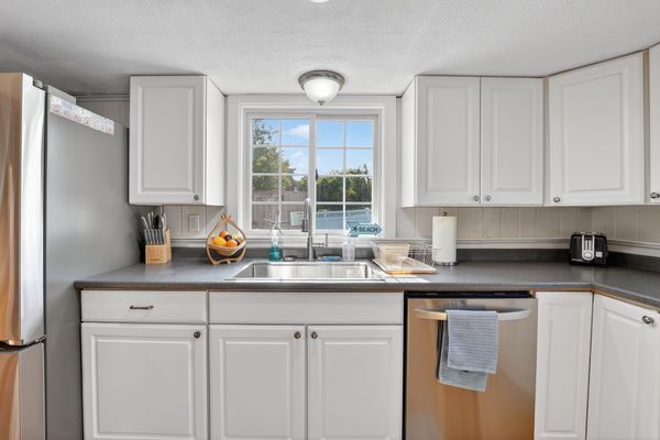 Bright, fully equipped kitchen with ample counter space, modern appliances, and everything you need to prepare meals during your stay.