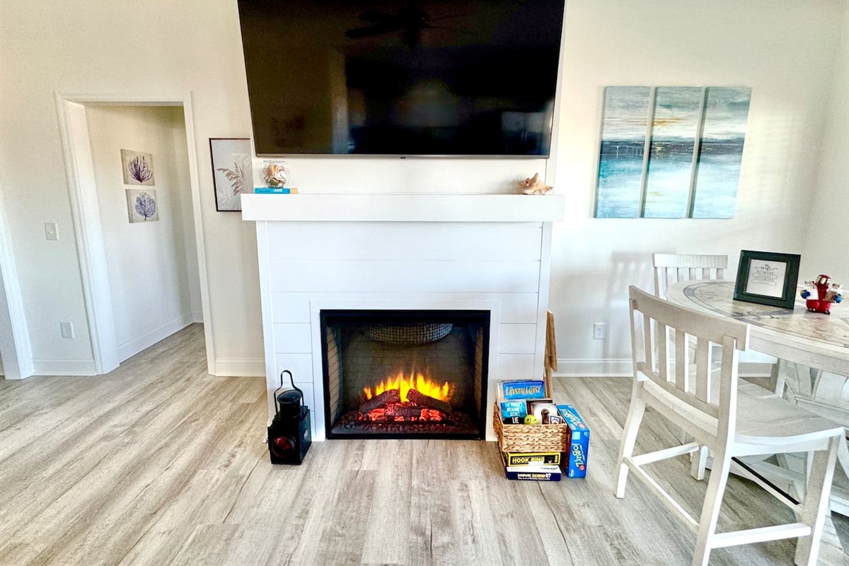 Get cozy while you relax in this living room with a fireplace and water view. Sofa bed features a Queen mattress. 