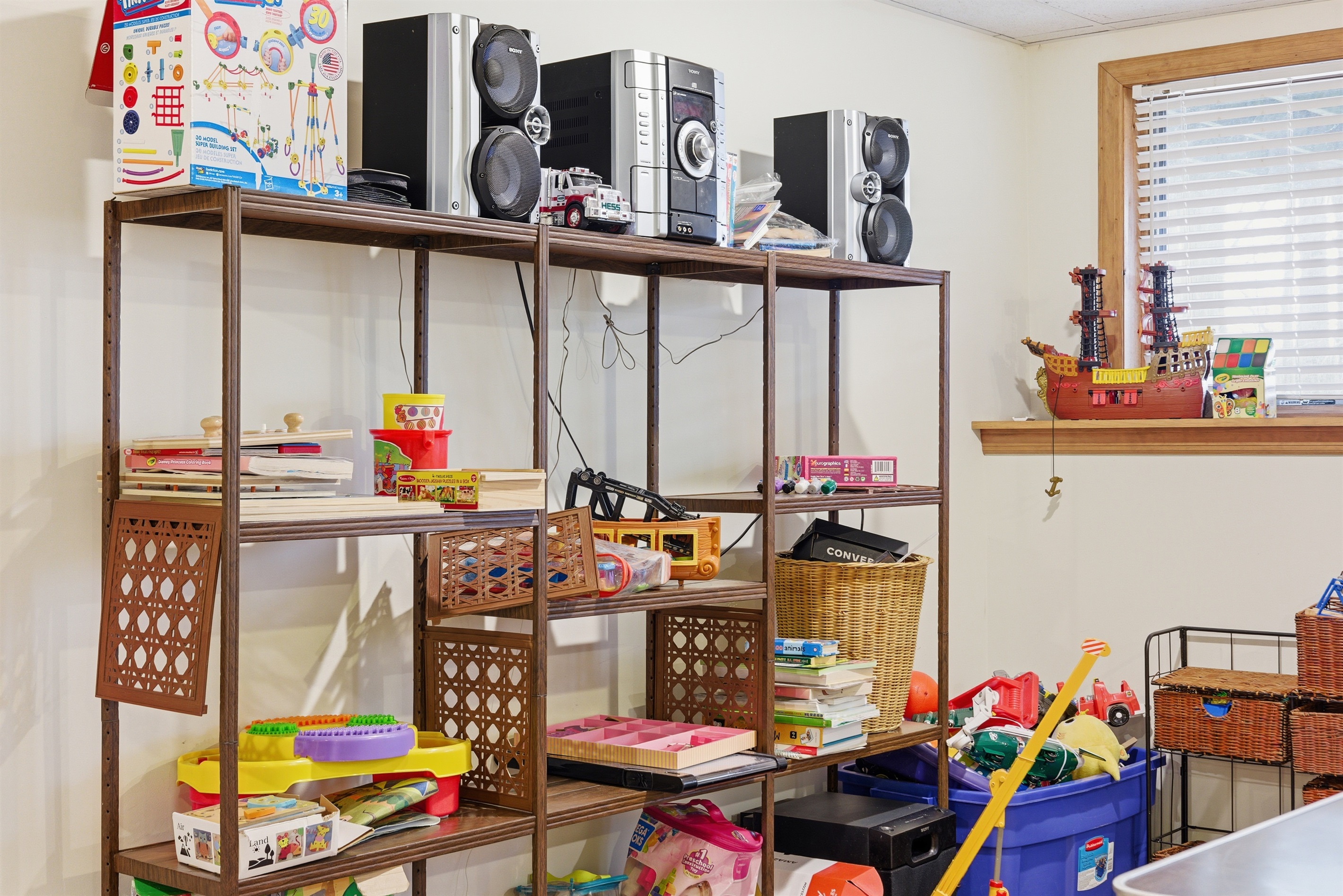 Playroom for kids and adults.  Air hockey, stereo system, toys, arcade, seating area.