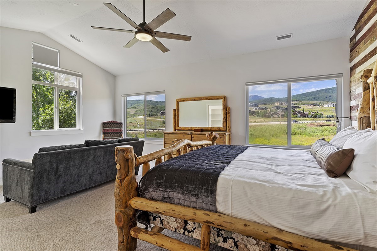Wake to breathtaking mountain panoramas in this tranquil primary suite, where comfort and elegance come together seamlessly.