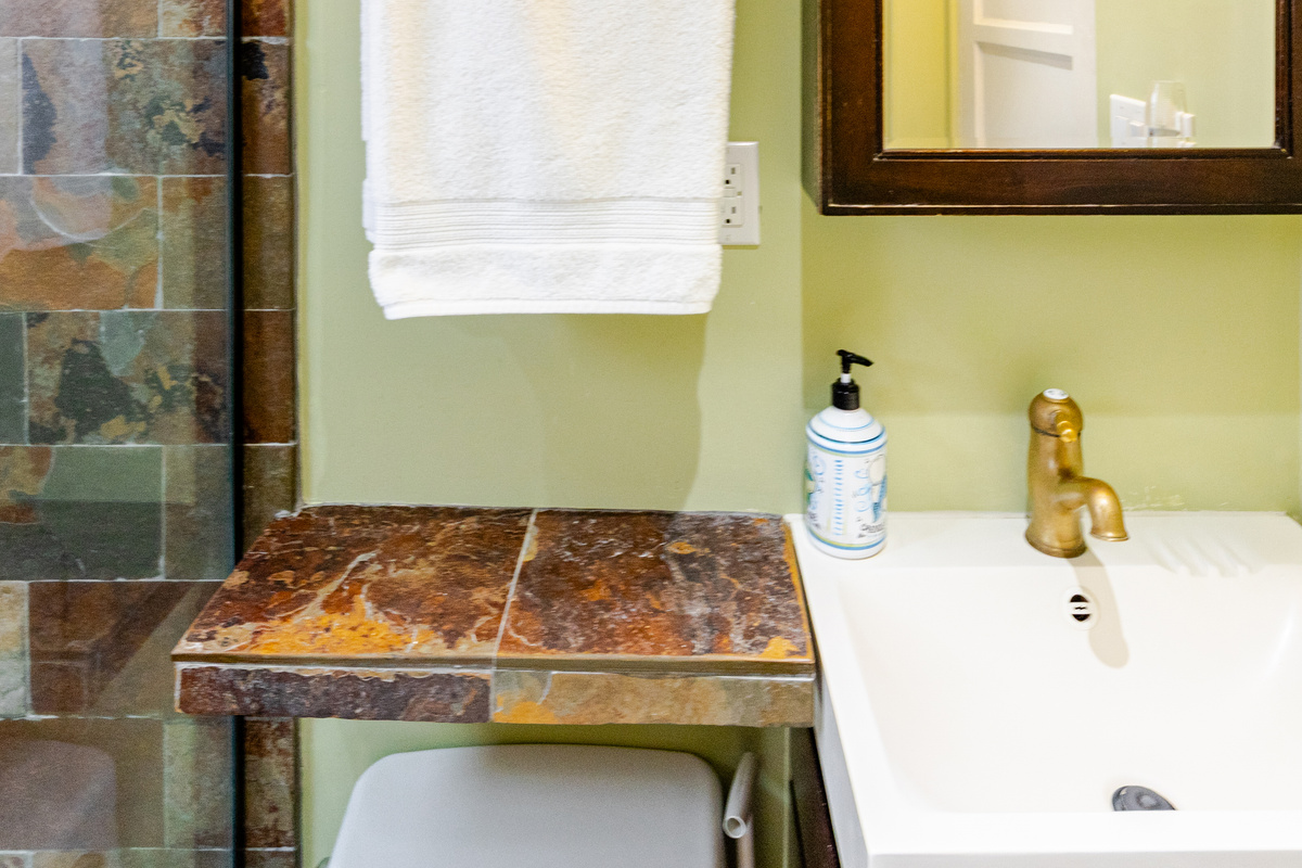 Bathroom is stocked with hair dryer and first aid kit.  Storage options include medicine cabinet and floating drawers underneath sink.