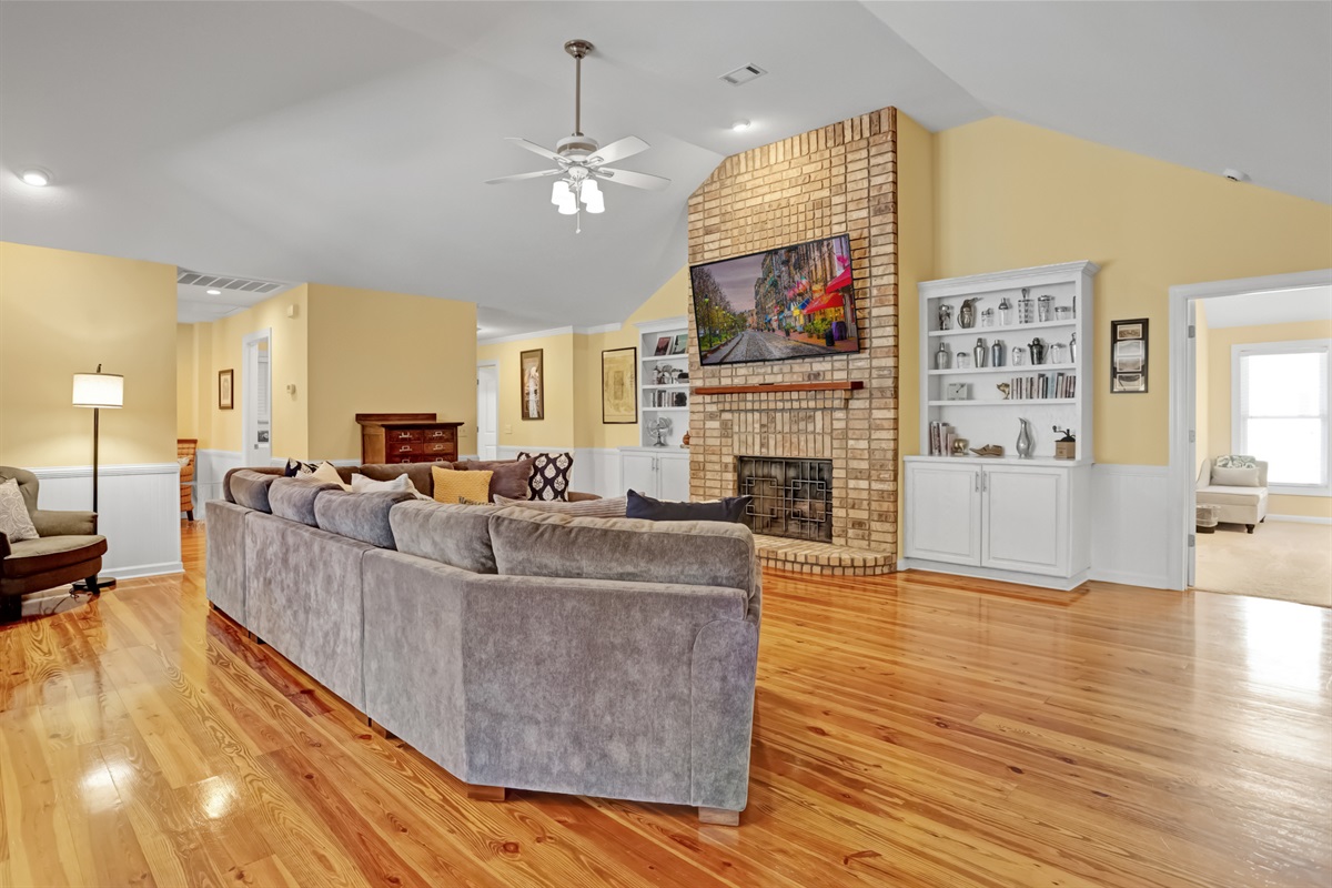 Large open-concept living room with vaulted ceilings and cozy seating—ideal for family movie nights, game time, or simply relaxing together.