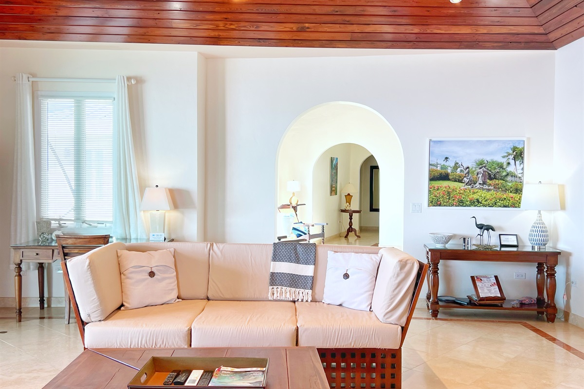 The living room has plenty of seating, air conditioning, and a large smart TV.