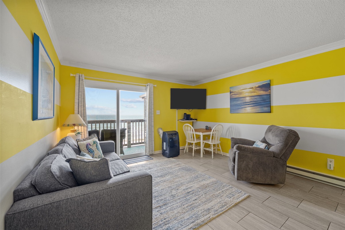 Bright coastal lounge with sofa, recliner, and a cozy spot to gather, watch TV, or unwind
