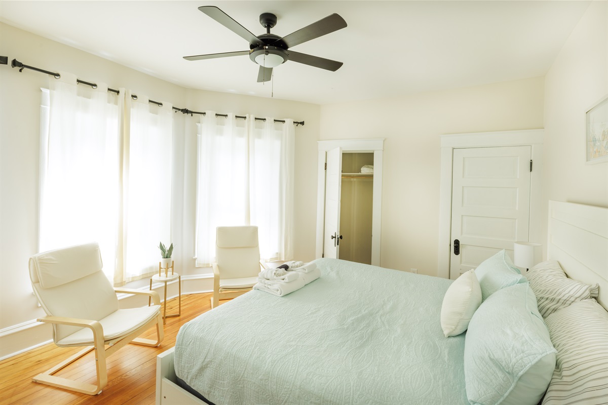Large King Bedroom with extra seating, clothing storage.