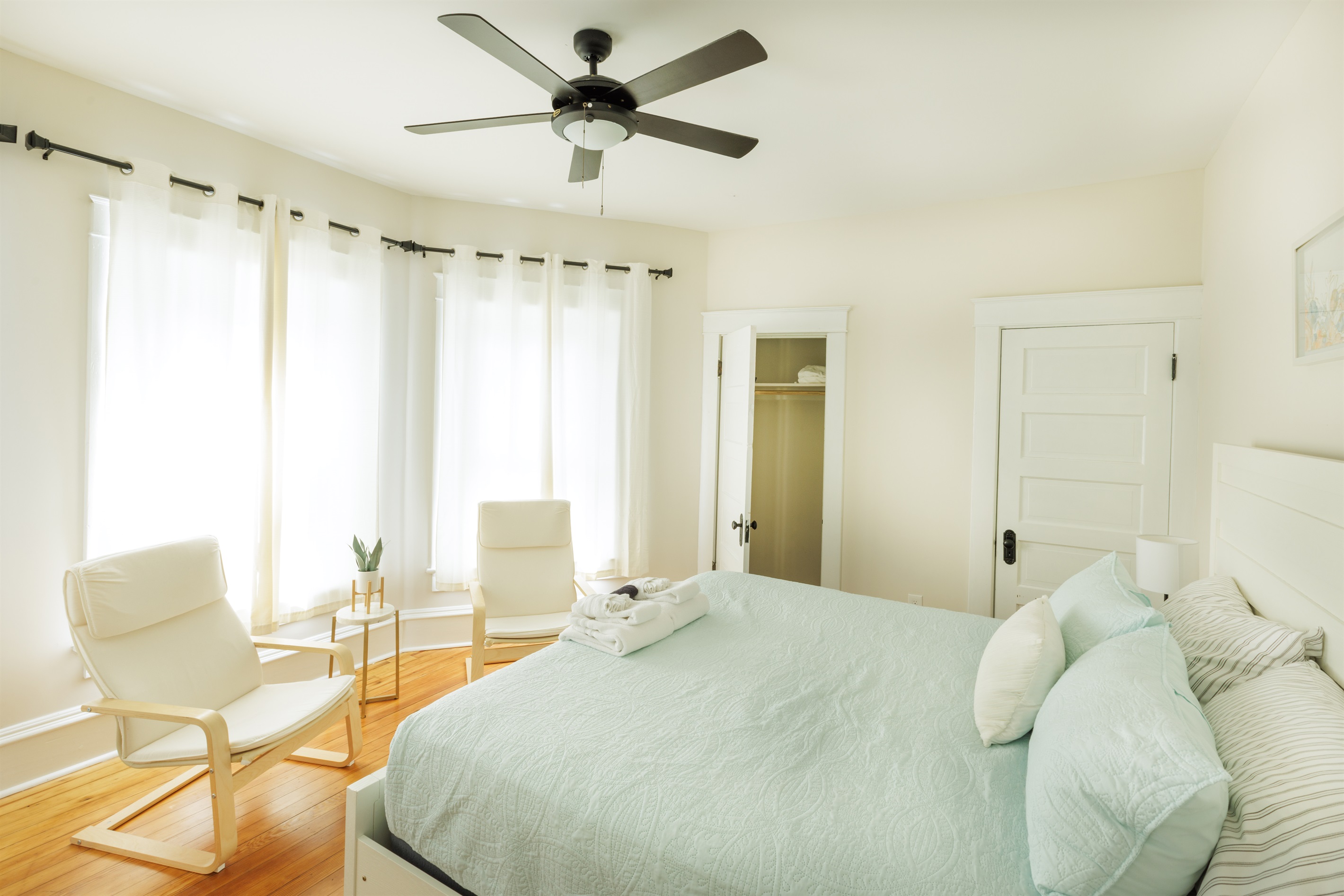 Large King Bedroom with extra seating, clothing storage.