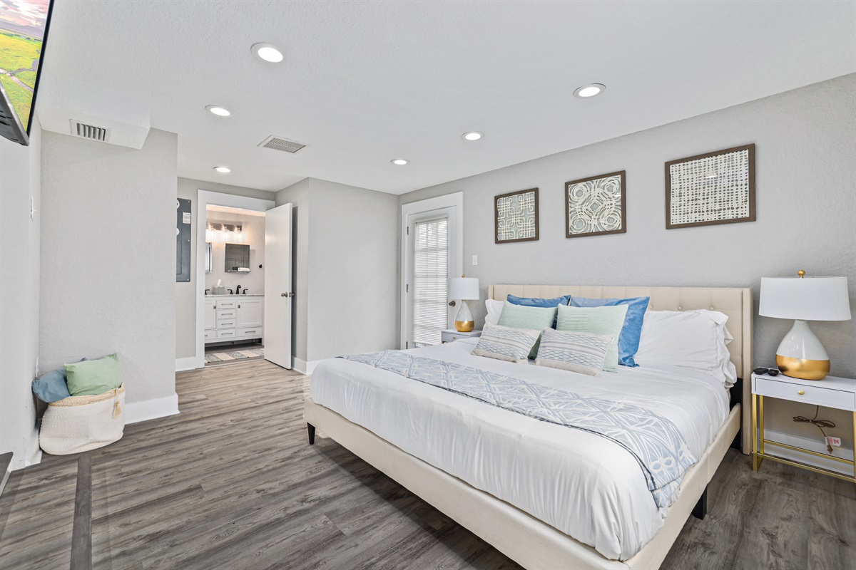 Primary bedroom with king sized bed and smart TV