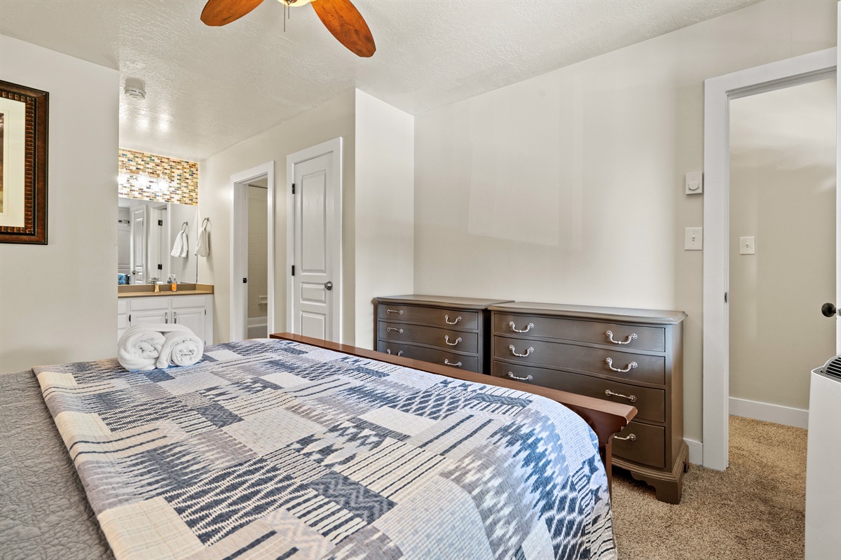 Primary bedroom includes private ensuite and soft lighting for cozy comfort.