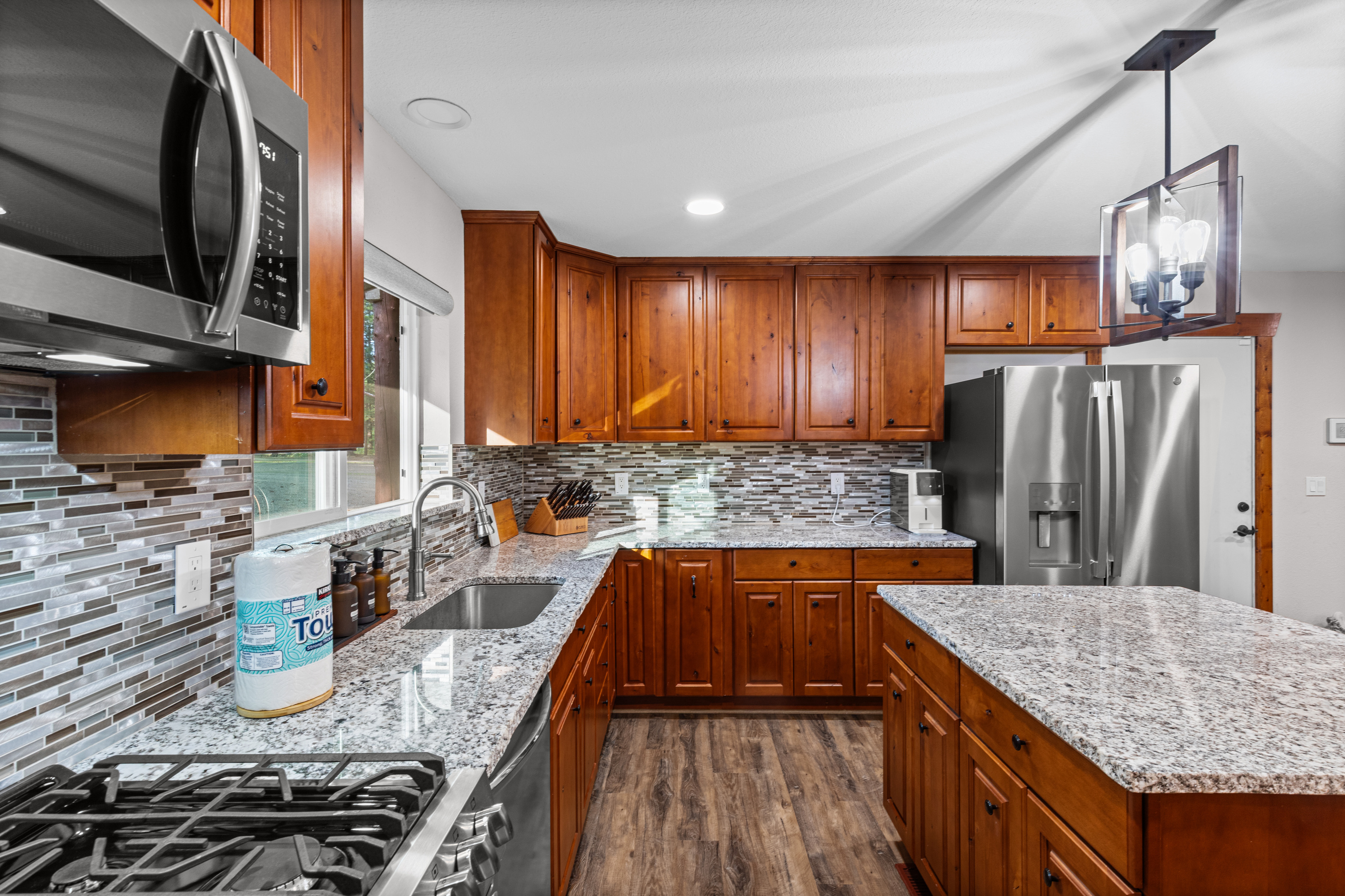 Kitchen with oven, island and refrigerator