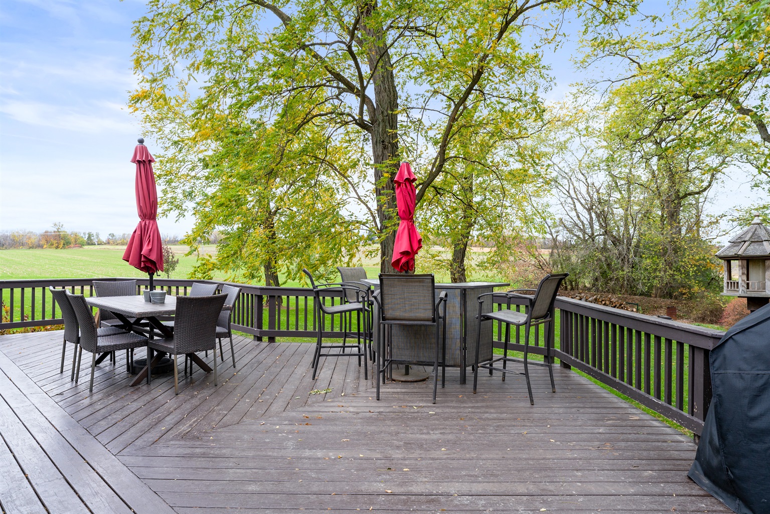 Expansive wraparound deck with dining set — unwind with coffee in the morning or wine at sunset.