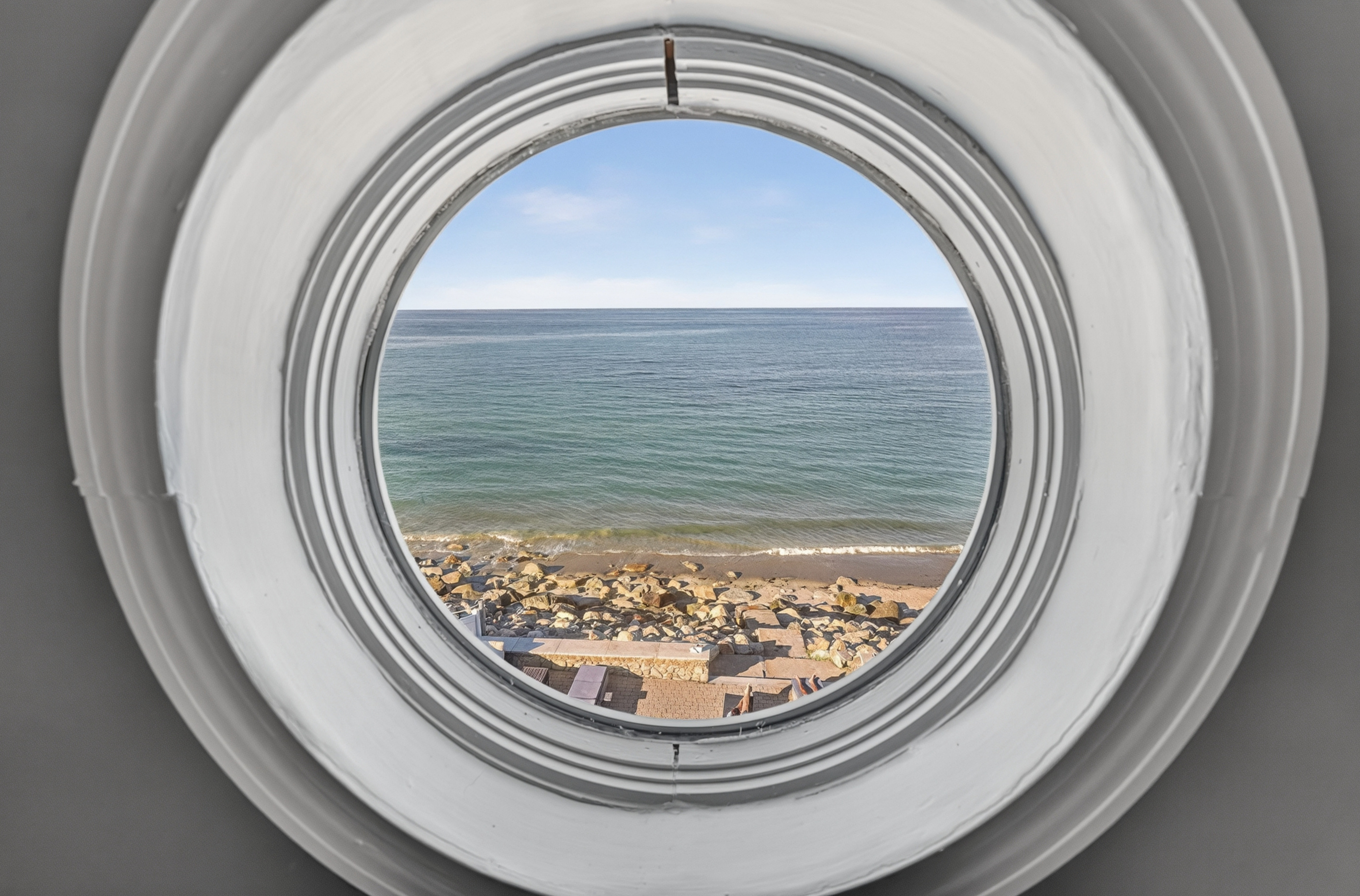 Enjoy beautiful water views through this unique porthole window.