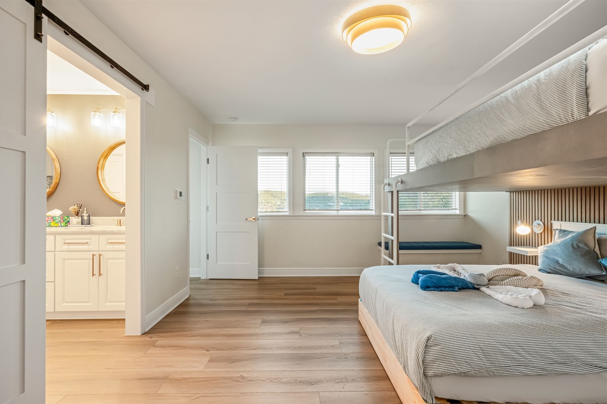 Another view of the versatile bunk bedroom with easy access to the nearby bathroom.