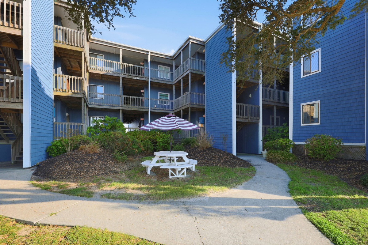 Located within a peaceful coastal community featuring landscaped walkways, shaded areas, and easy access throughout the property