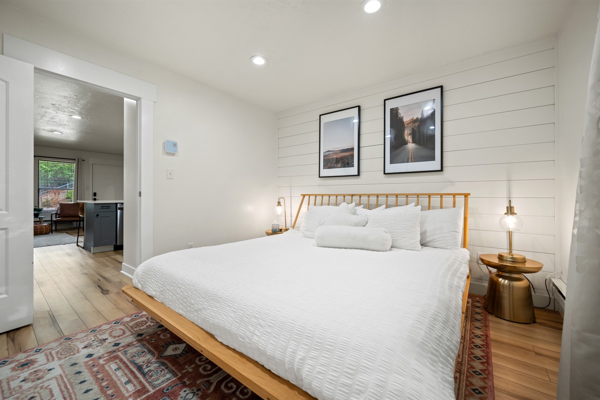 The bedroom is located just down the hall from the kitchen and living area.