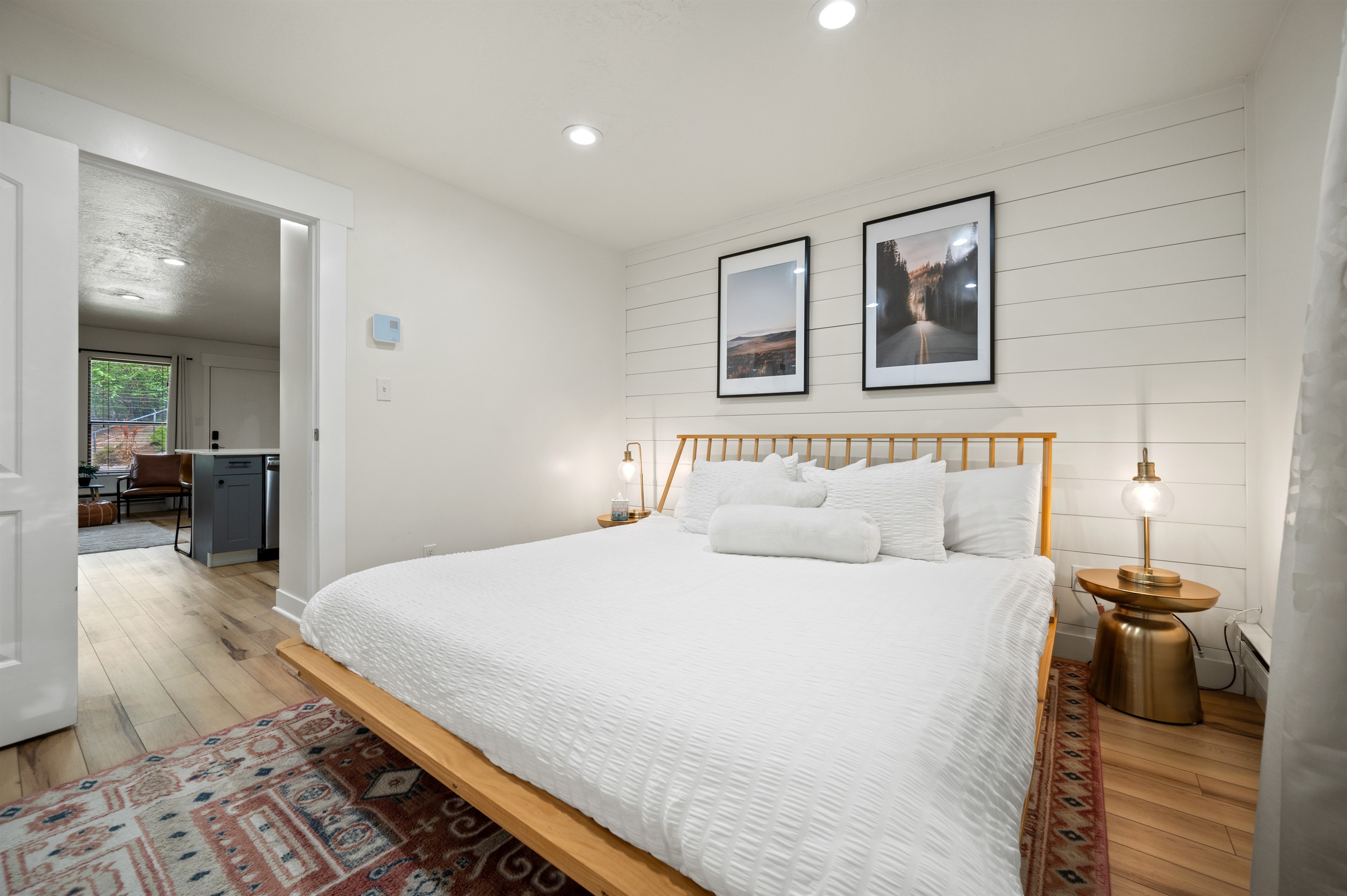 The bedroom is located just down the hall from the kitchen and living area.
