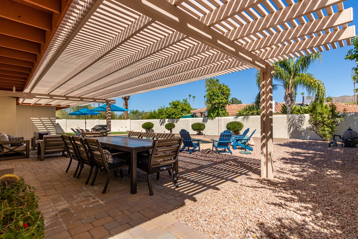 awesome backyard with sparkling pool, newly installed putting green, outdoor dining + lounge seating + corn hole