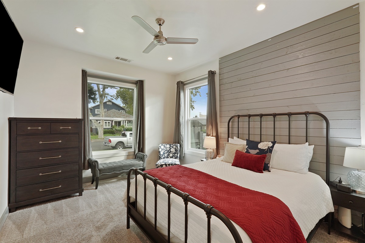 The second bedroom has a queen-sized bed, full dresser, smart TV, and a closet.