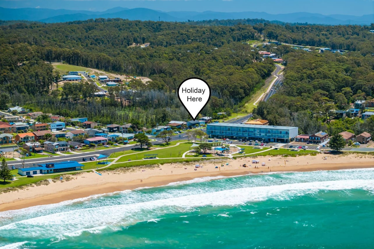 This sky view helps show Skye’s Beach House in context, with the large beach-house layout and surrounding Malua Bay streets visible.