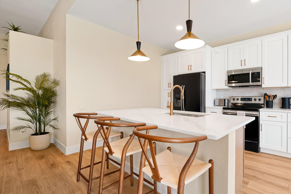 Kitchen: Fully renovated kitchen with a spacious island, seating for three, abundant cabinetry and modern appliances.
