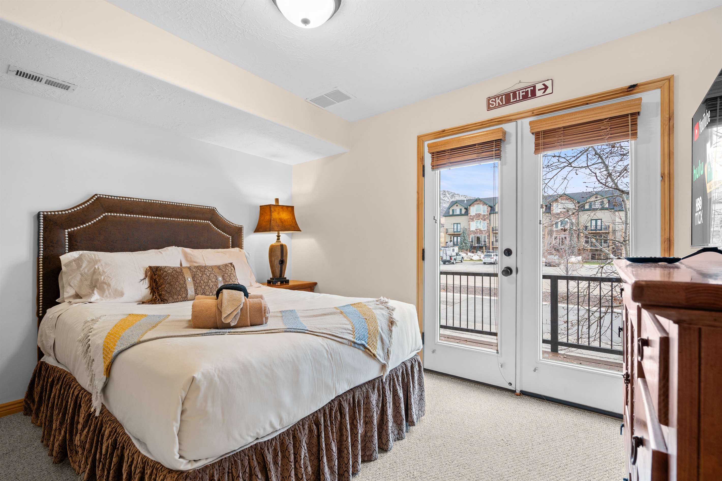 Comfortable second bedroom featuring a queen bed, natural light, and a peaceful mountain atmosphere.