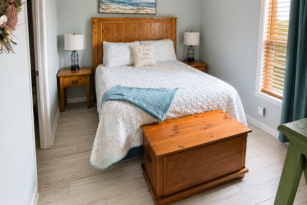 Cozy, peaceful bedroom with comfortable bedding-the perfect place to recharge after a day at the beach.