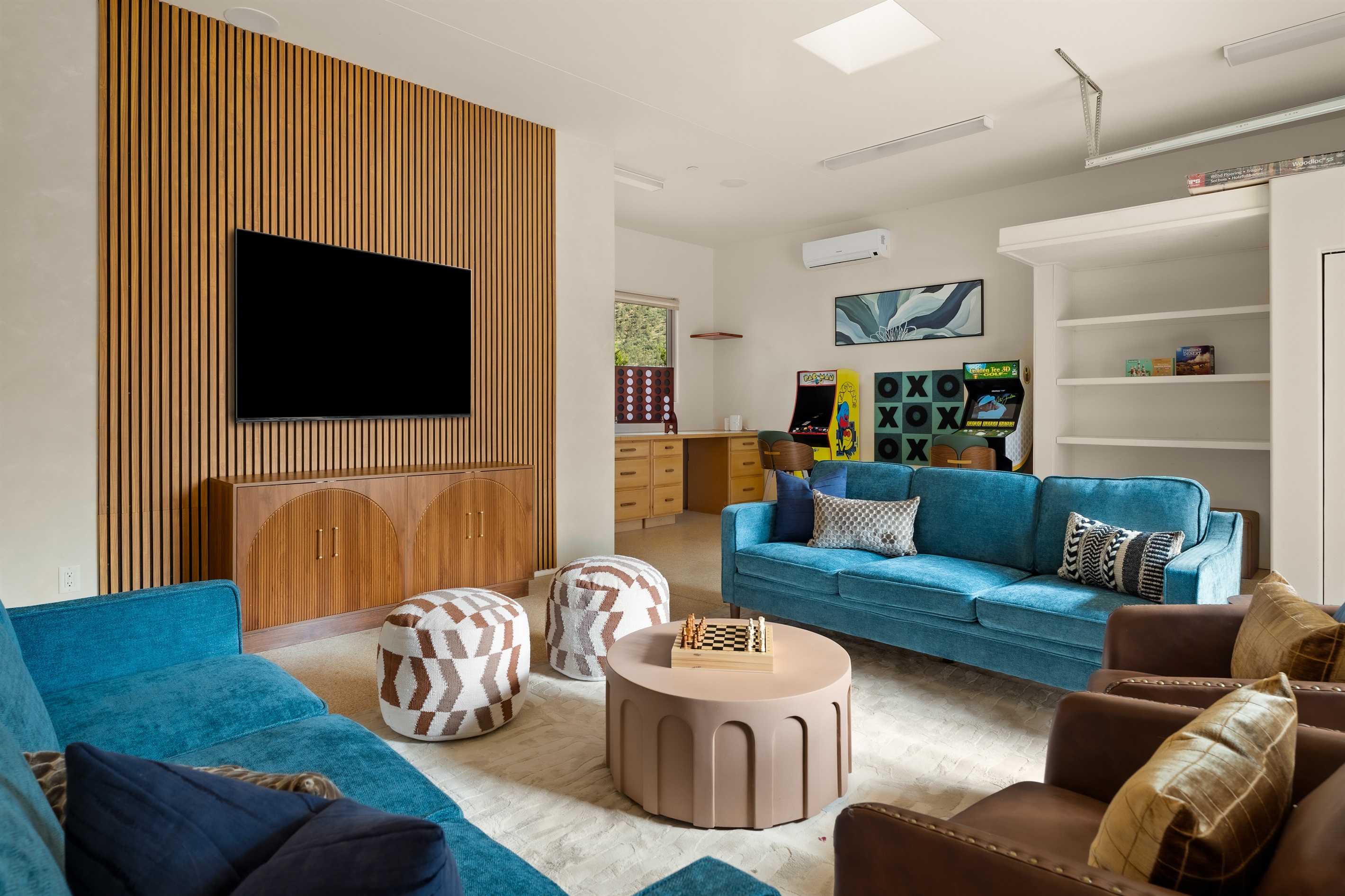 The ultimate entertainment lounge. Our converted garage game room features a massive smart TV, stunning custom wood accents, plush seating, and endless activities for all ages.