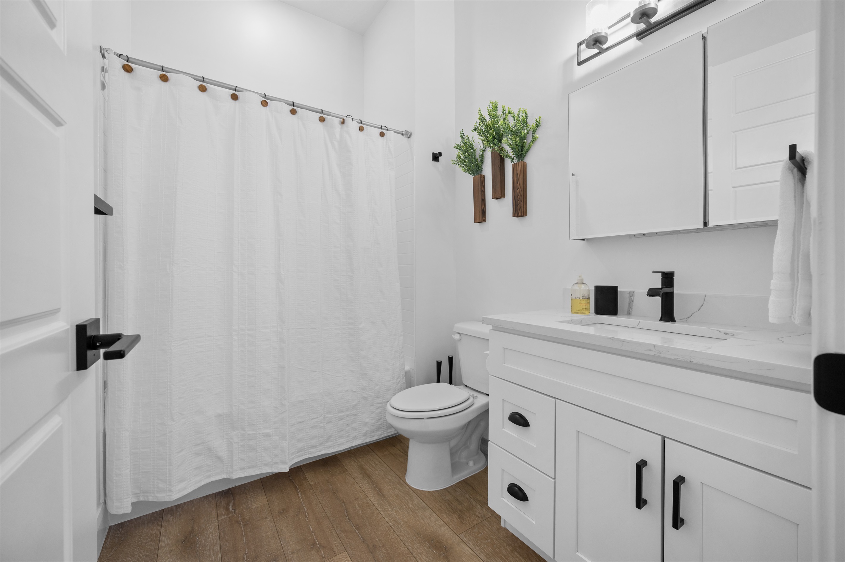 Primary bathroom with full tub-shower combination, vanity, and modern fixtures.ry Bath