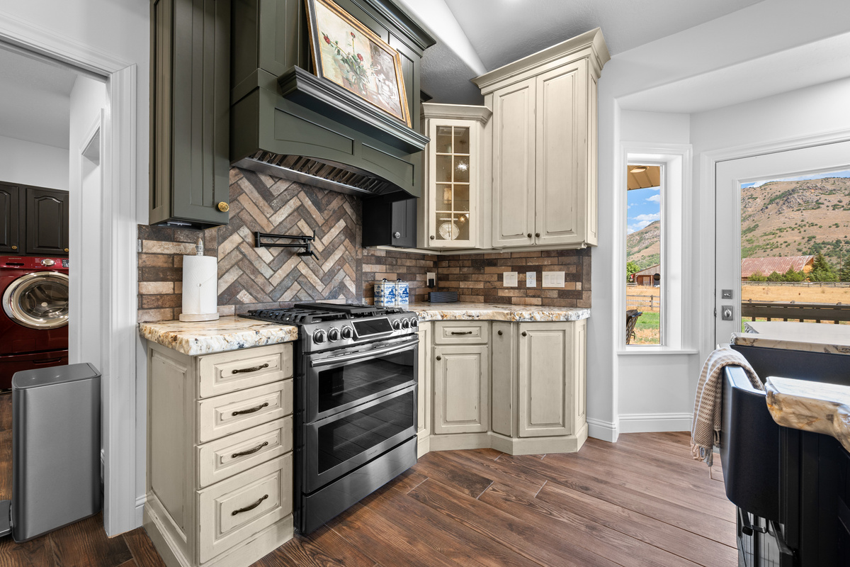 The kitchen’s range, expansive cooking surface, and richly textured finishes create an impressive setting for home-cooked meals.