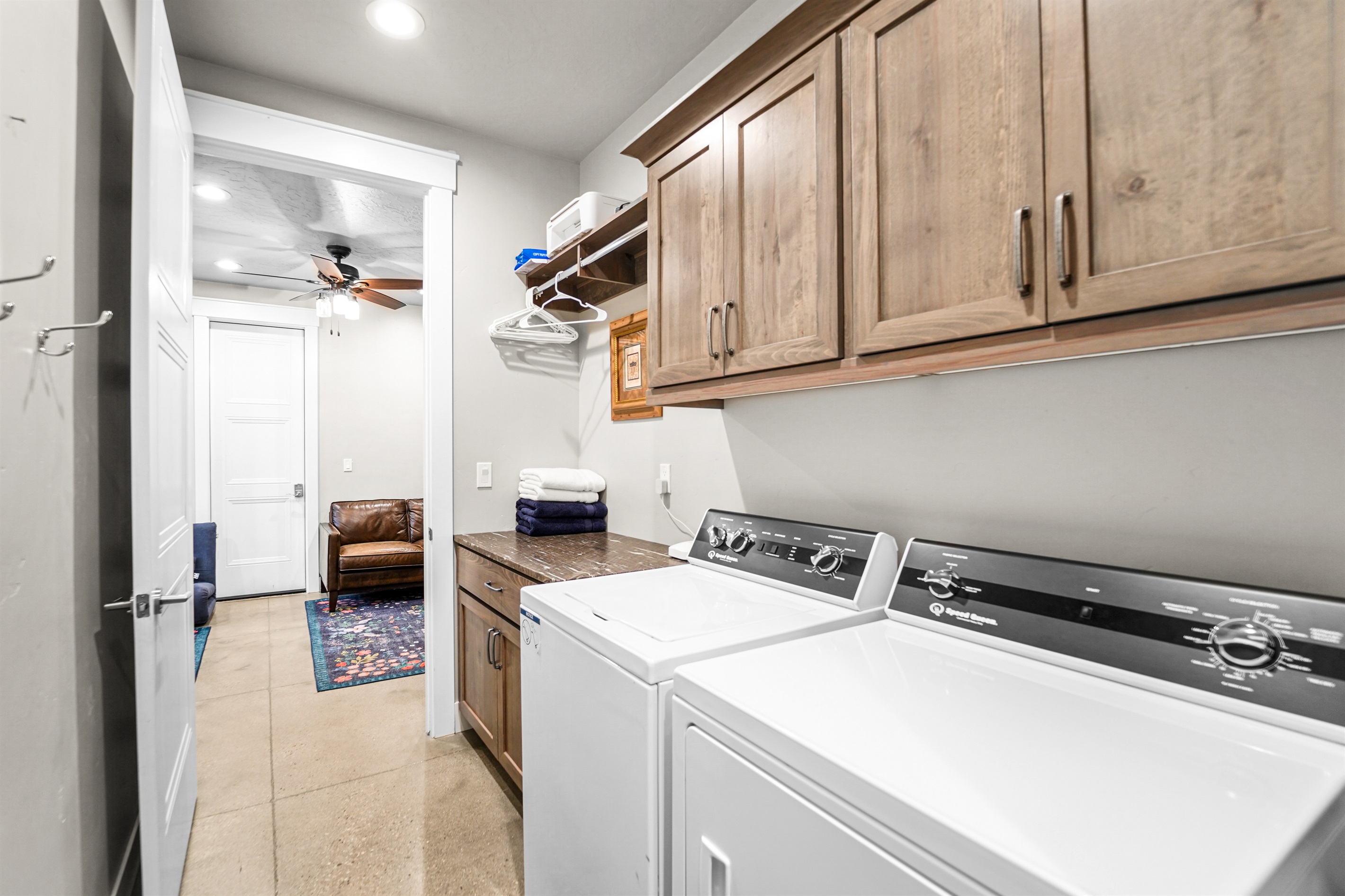 Practical and stylish laundry space with beautiful wood cabinetry.