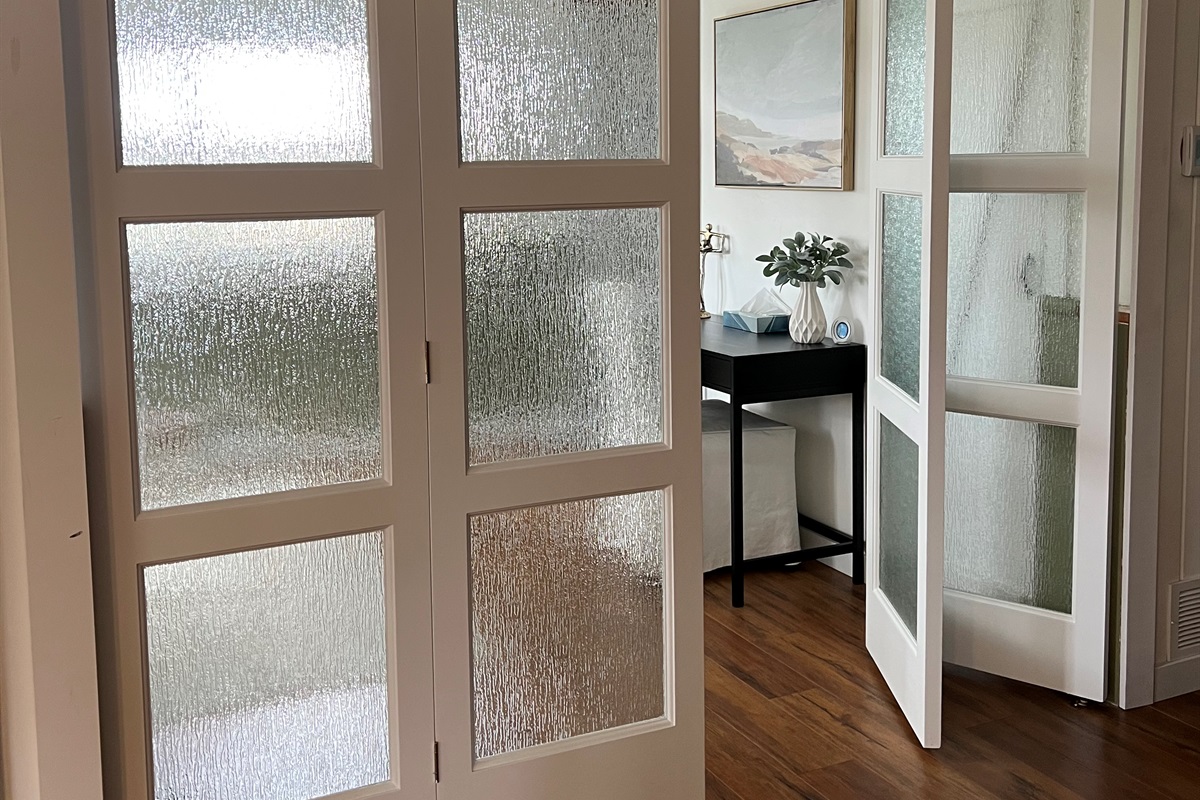 Glass doors provide privacy for individuals using the den for sleeping quarters.