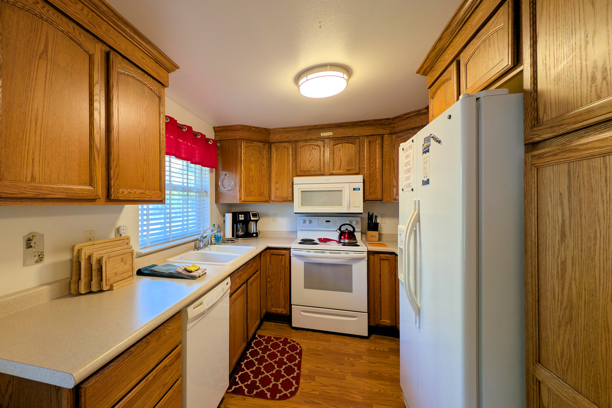 overview of kitchen with dishwasher electric range microwave