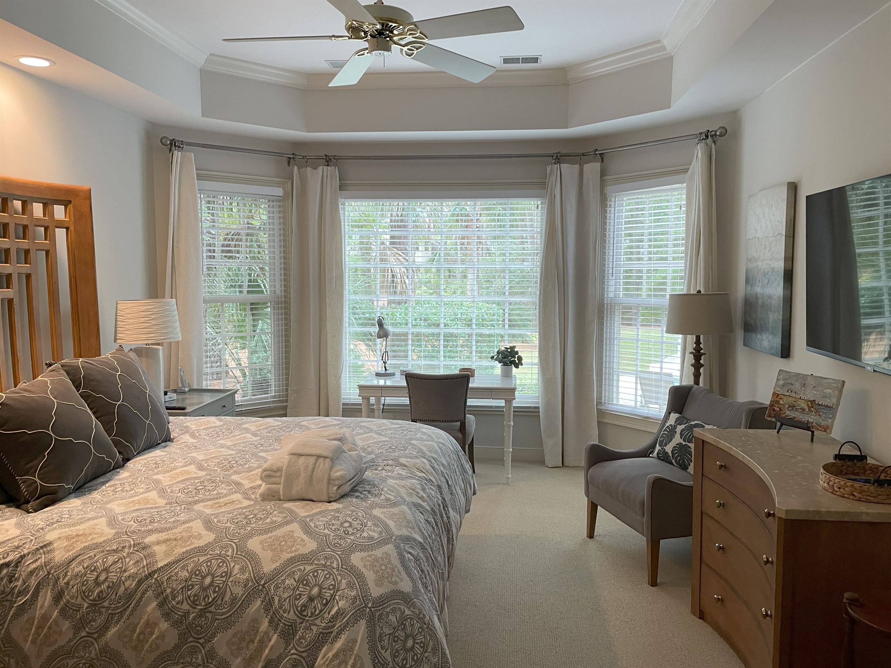 Master suite with king bed, desk and a great view of backyard and pool