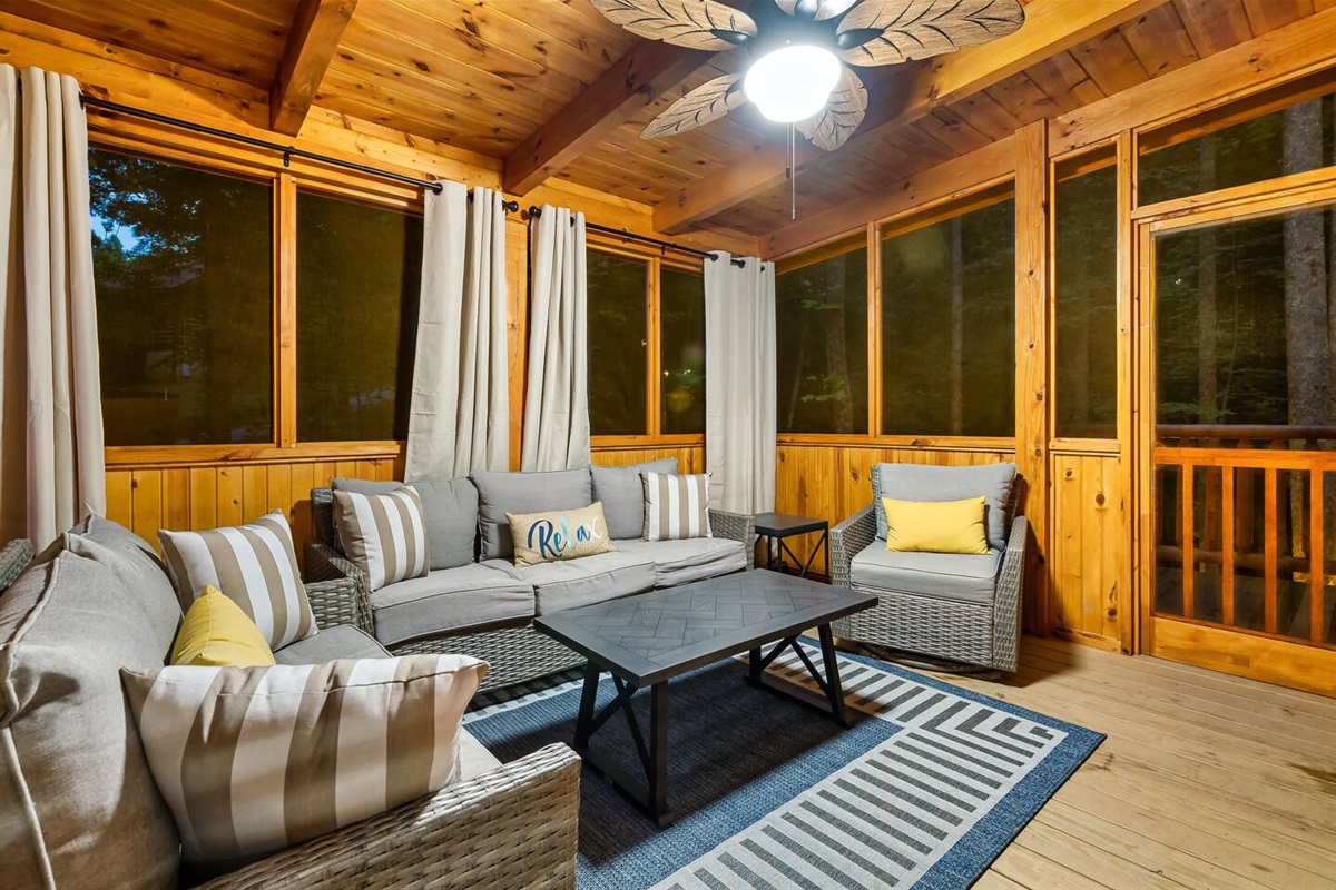 Screened porch to enjoy your morning coffee. One screen leads to wrap around porch with rockers and the opposite screen door leads to the hot tub area which has privacy.