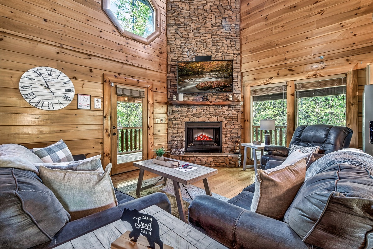 Relaxing living room includes queen sleeper sofa and electric fireplace.