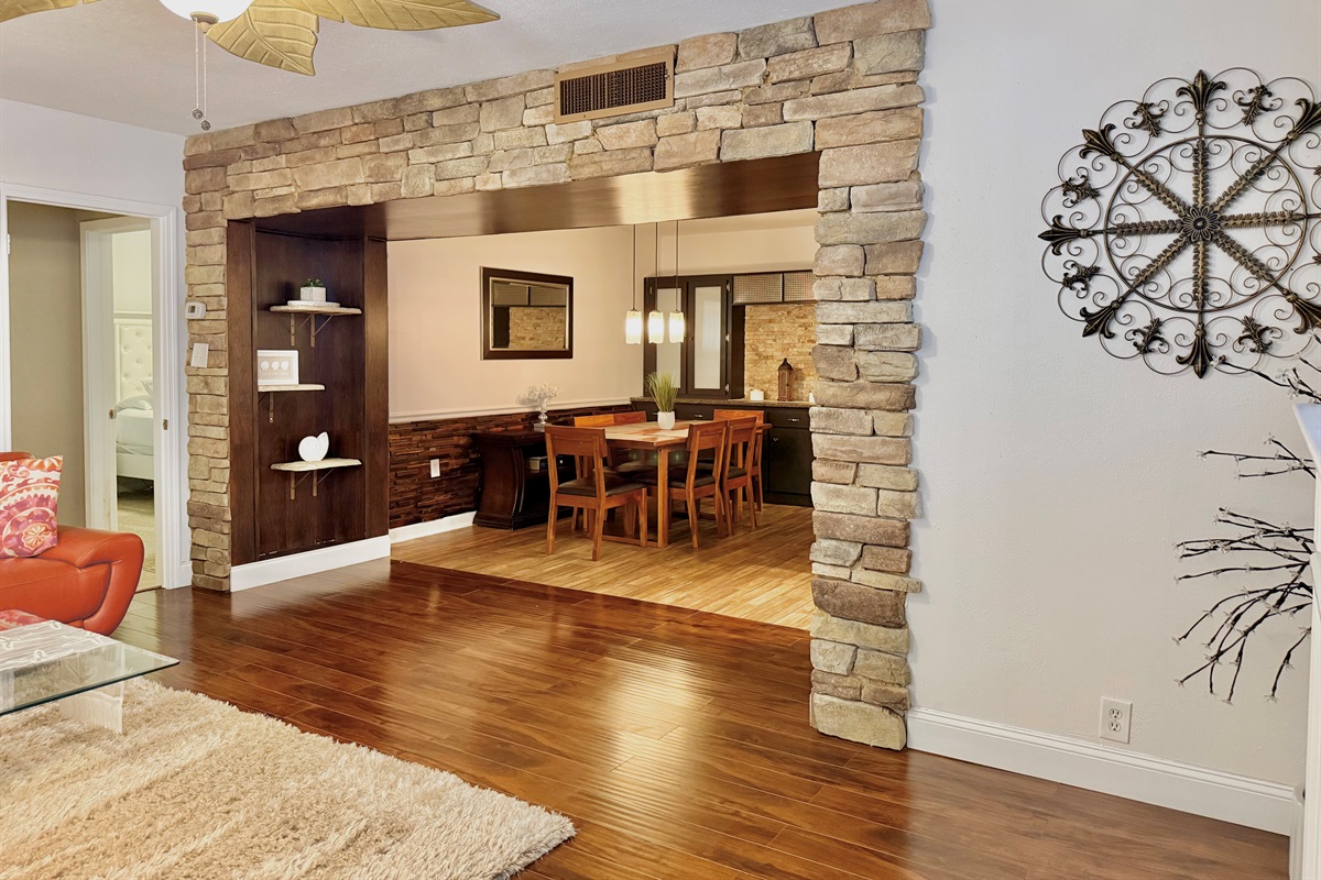 This elegant dining nook features rich wood tones, cushioned seating, and a chic centerpiece, creating a welcoming space for breakfast, dinner, or anything in between.