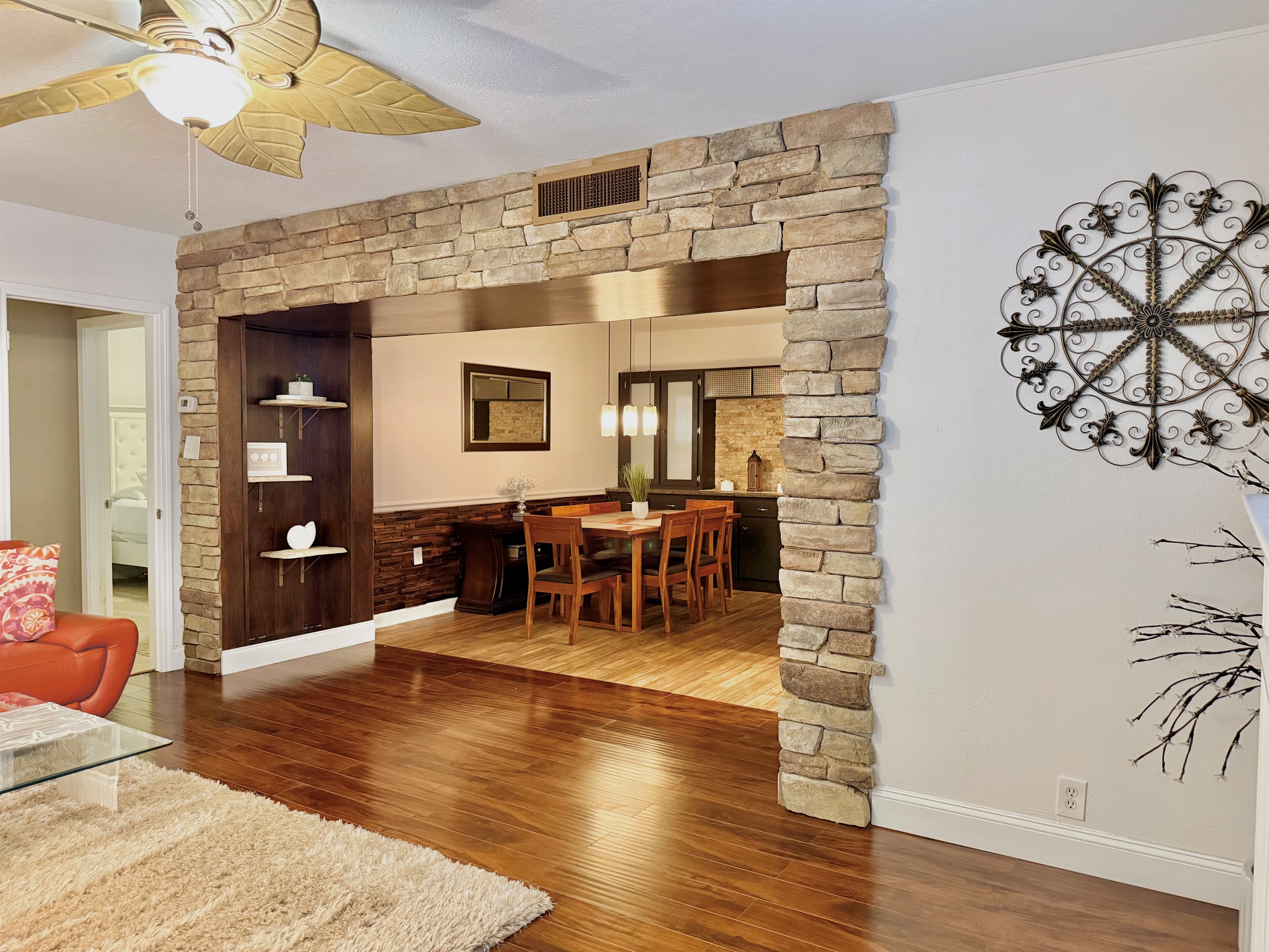 This elegant dining nook features rich wood tones, cushioned seating, and a chic centerpiece, creating a welcoming space for breakfast, dinner, or anything in between.