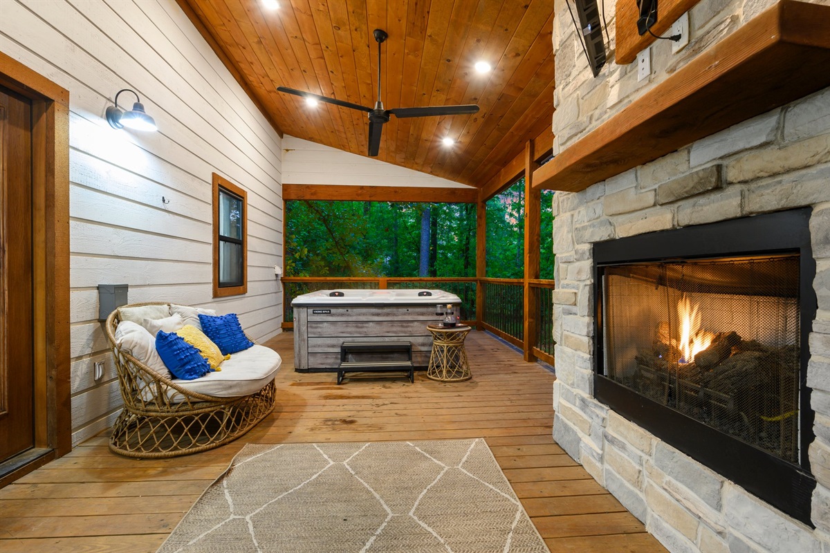 Veranda Retreat: Unwind in the hot tub, surrounded by nature and a warm, inviting fireplace!