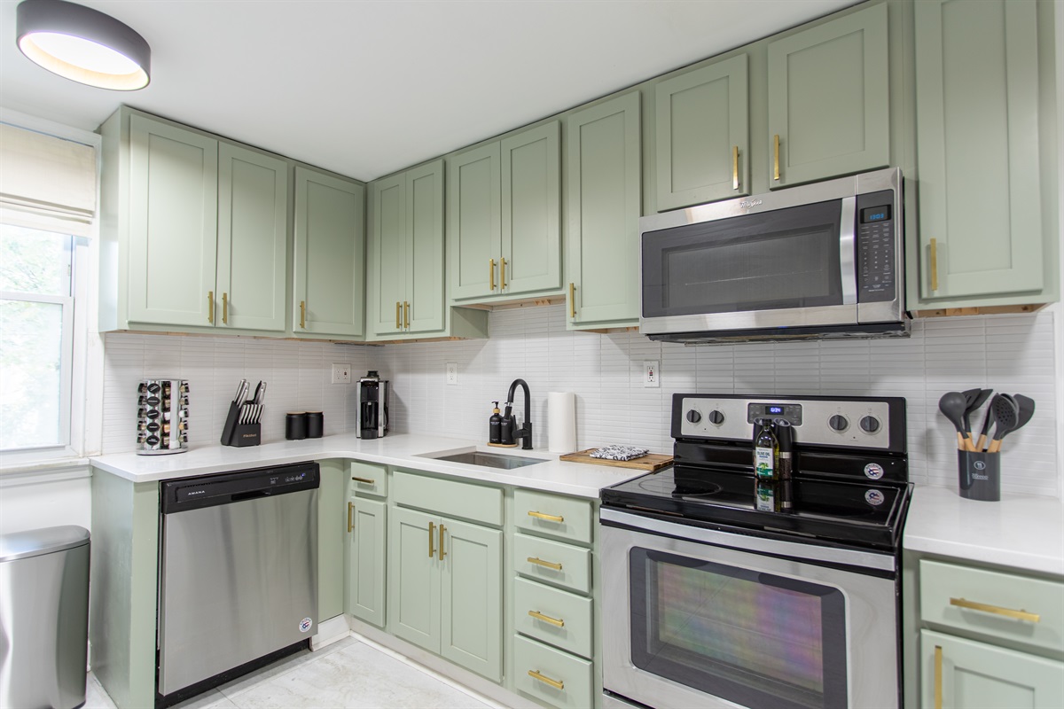 Spacious full kitchen featuring stainless steel and modern appliances.