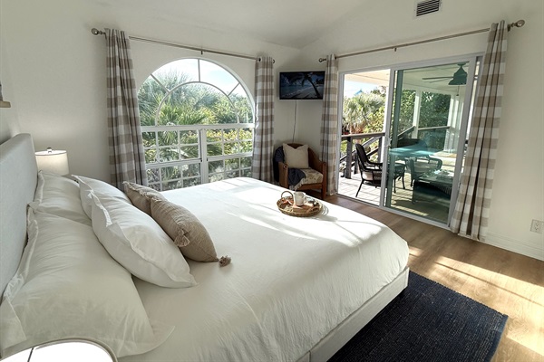 King bed, patio door opens to the large, comfortable front porch