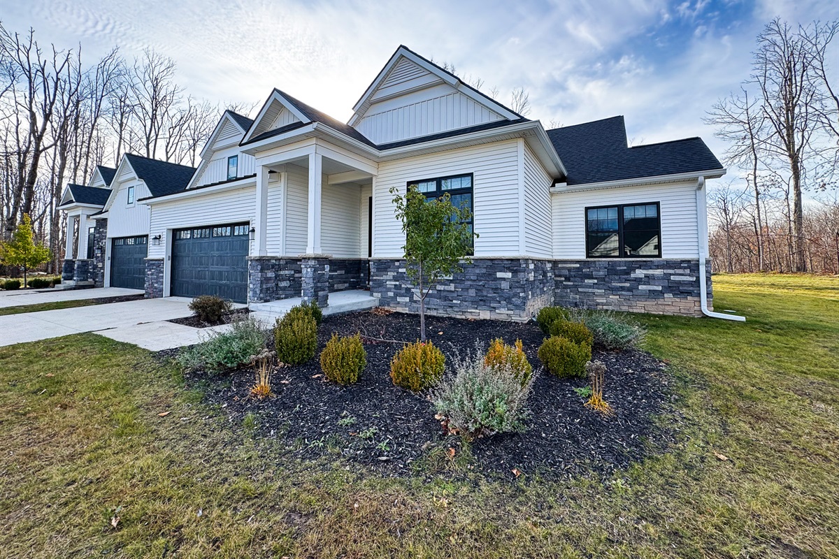 Perennial gardens surround the entry to this townhome.