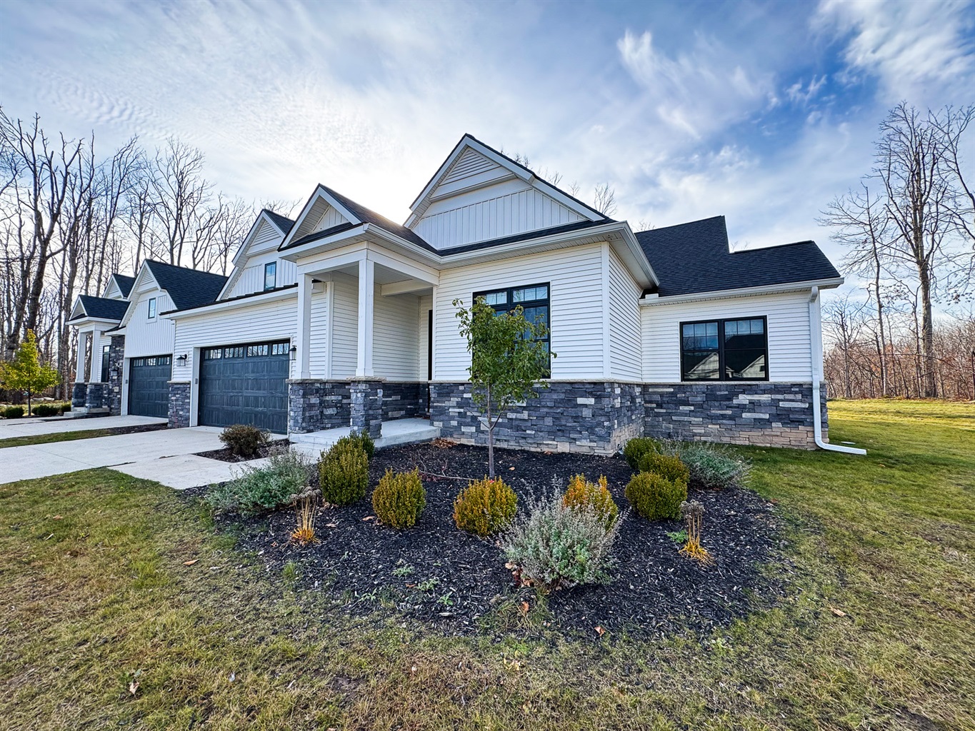 Perennial gardens surround the entry to this townhome.
