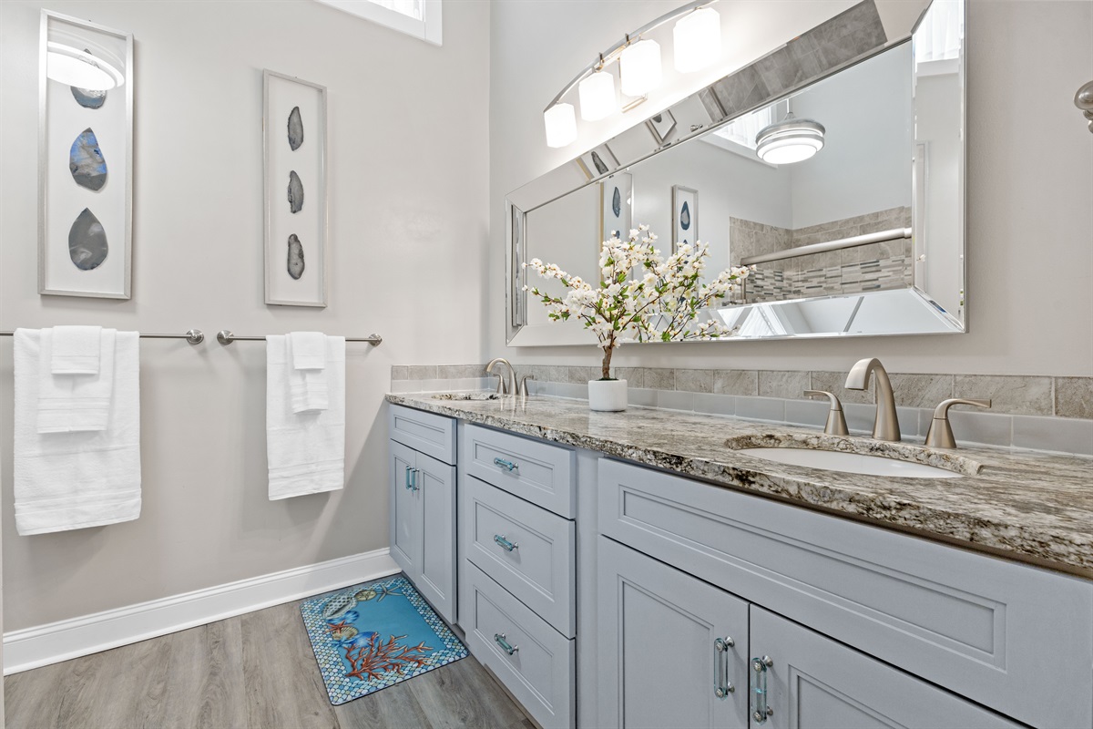 Bright master bathroom with dual sinks and modern finishes