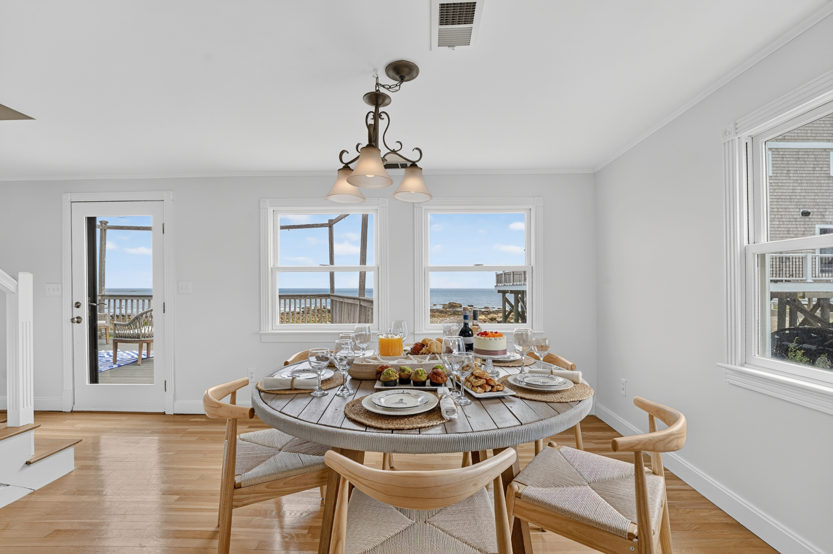 Share breakfast, dinner, or drinks around the dining table with the waterfront just outside.