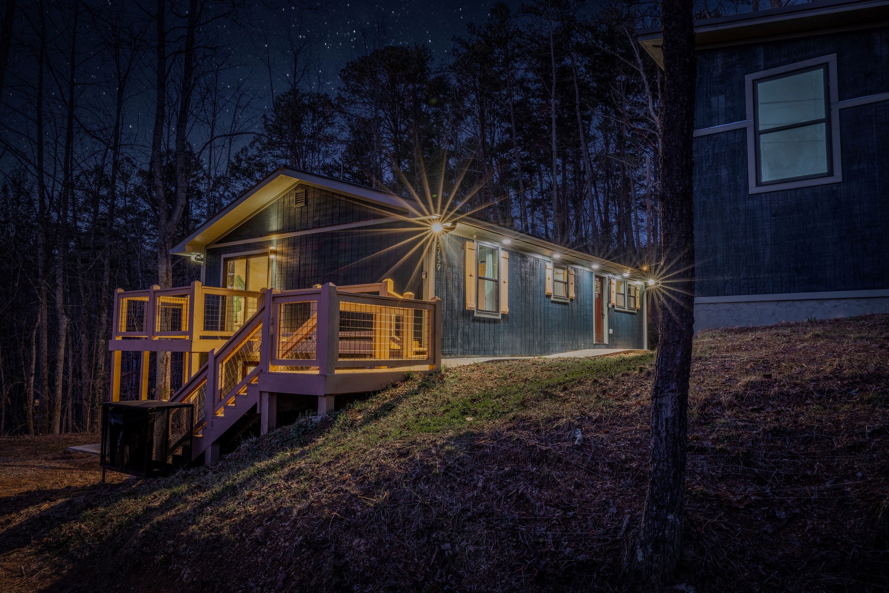 The striking architecture of Mid Mod Mountain Bliss is even more captivating at dusk, featuring designer lighting and forest views.