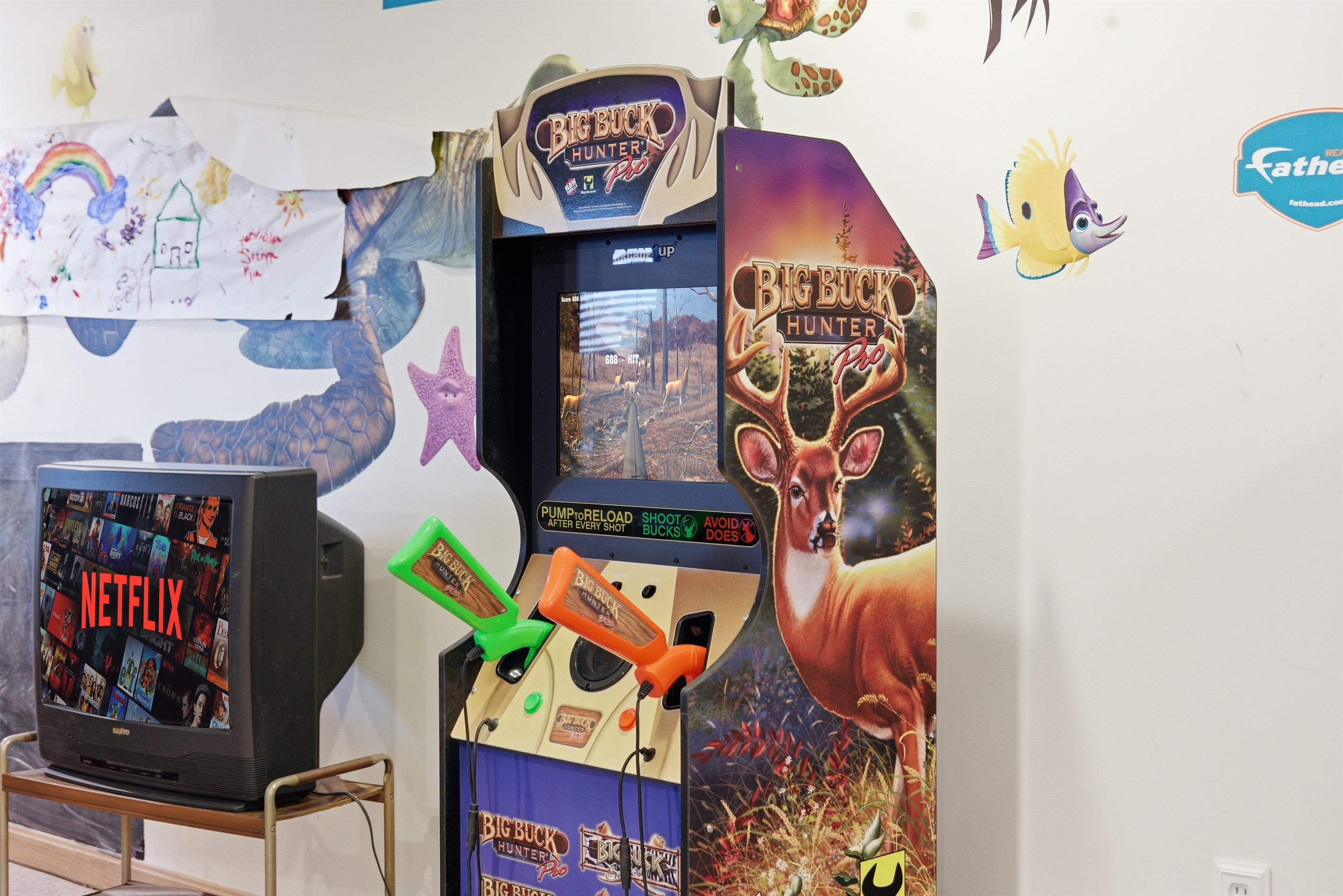 Playroom for kids and adults.  Air hockey, stereo system, toys, arcade, seating area.