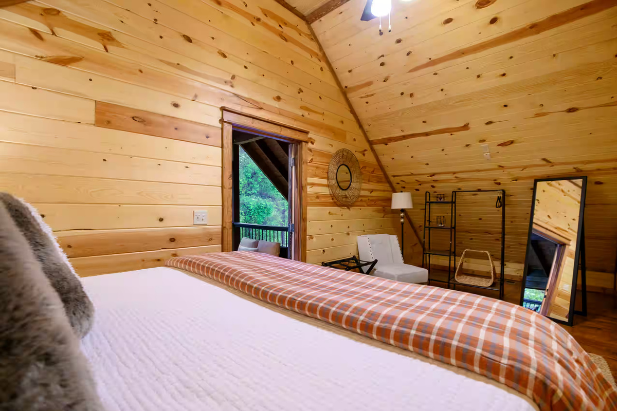Loft Bedroom: Embrace nature with scenic views and stylish wood accents in your private retreat!